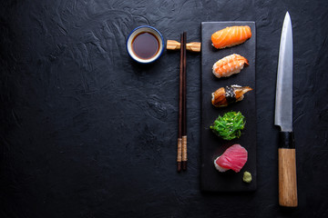 Set of sushi on dark stone table. Top