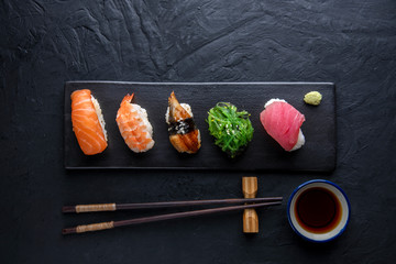 Set of sushi on dark stone table. Top © Hyper Bee