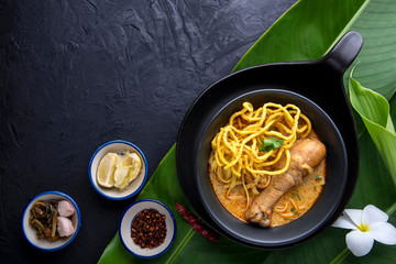 Thai noodle, Khao Soi Curried Noodle Soup with Chicken on dark background
