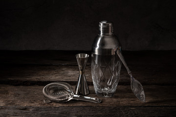 bartender equipment shaker strainer jigger on wood background with copy space