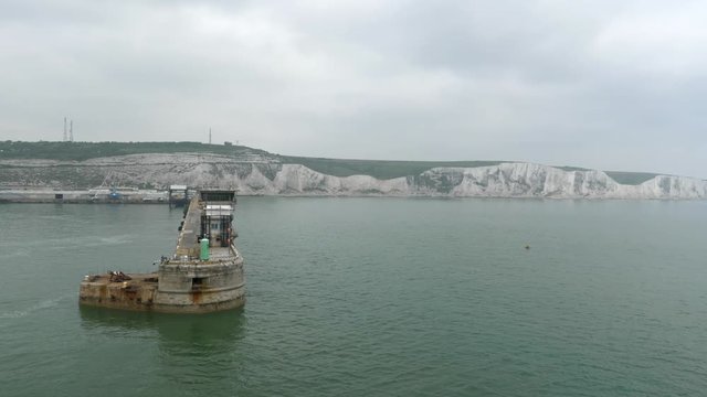 View from a boat arriving at Dover port with the white cliffs in the horizon.