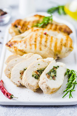Grilled spinach stuffed chicken fillets, sliced. Selective focus, space for text.