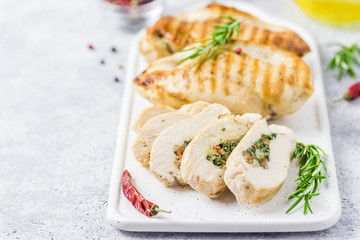 Grilled spinach stuffed chicken fillets, sliced. Selective focus, space for text.