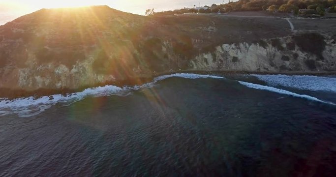 Sunset over coastline cliffs at Zuma Beach, Malibu, drone view