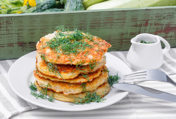 Delicious pancakes from courgettes and fresh vegetables with sour cream and dill