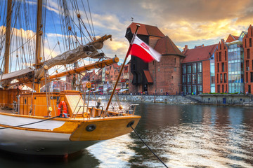 Obraz premium Beautiful port crane and the old town of Gdansk at sunset, Poland.