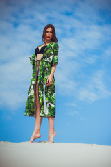 Fashion woman posing on the sand dune