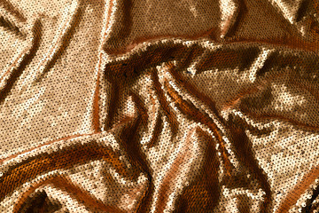 Golden sequins fabric texture. Top view.