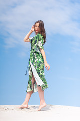 Fashion woman posing on the sand dune