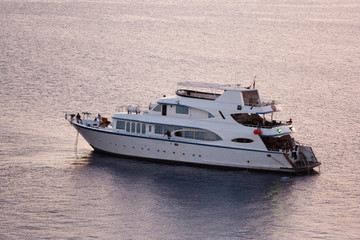 pink sunset sea view with big white yacht boat