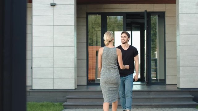 Caucasian man embracing blonde woman. Joyful man tenderness meeting wife