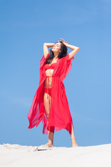 Summer Fashion. Sexy European Woman In Red Swimsuit On Beach