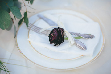 Plate with a black rose on it
