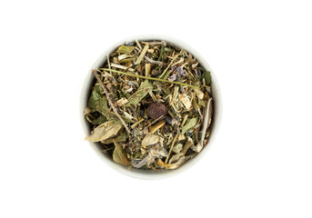 Dry herbal tea mix in ceramic bowl isolated on white, top view