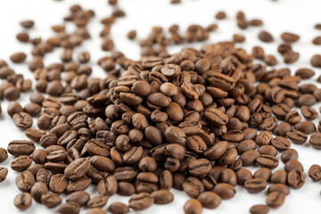 Roasted coffee beans on white background, close-up