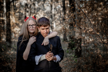 Teenagers in Halloween costumes in the woods