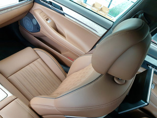 Front passenger seat in the car. Leather chair Brown interior.