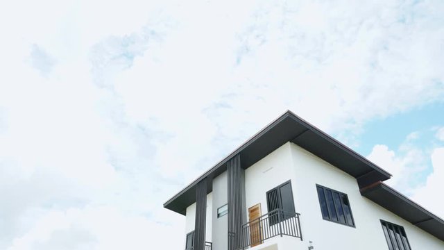 The video of the time lapse of the sky and the clouds with the house as the front