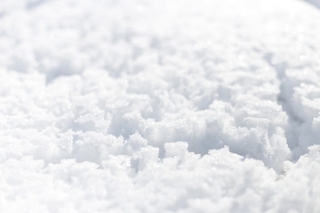 Snow in the park bright sunny winter day. There are traces of rain on the snow. Background.