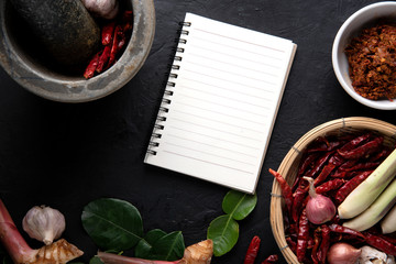 recipe book with fresh herbs south Asia and spices on wooden background, thai food. top view.
