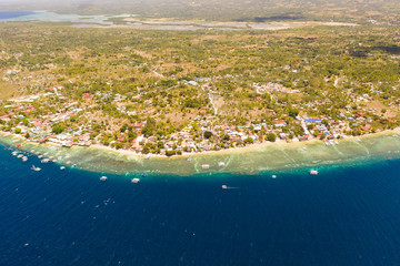 Coast of Cebu island, Moalboal, Philippines, top view. Philippine boats in a blue lagoon over coral reefs. Moalboal is a great place for diving and vacations.