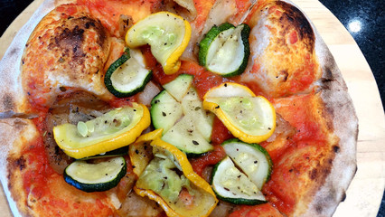 Closeup of handmade fresh cucumber pizza, bread with ketchup sauce and fresh cucumber vegetables.