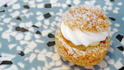 A cream puff in plate, handmade snack and dessert.