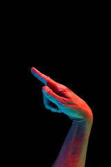 Bright fluorescent colorful hands isolated on a dark background. Close-up.