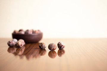 Fototapeta na wymiar Hazelnuts, filbert in burlap sack on wooden backdrop. heap or stack of hazelnuts. Hazelnut background, healty food