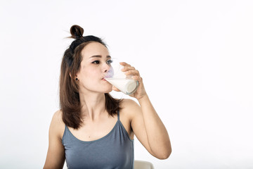 young woman drinking milk on table