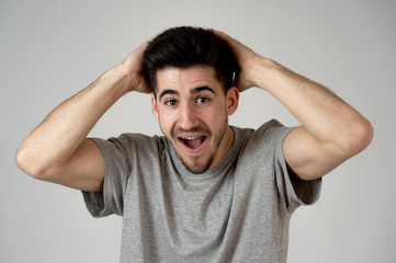 Close up portrait of young man with excited facial expression surprised of success