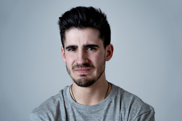 Fototapeta premium Human expressions and emotions. Portrait of young attractive sad and depressed man