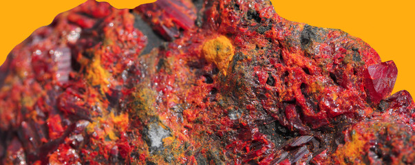 Realgar, arsenic sulfide mineral with a large red ruby on an orange background