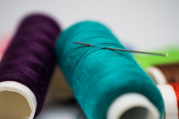 Coil with mint cotton thread and needle eye close up