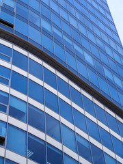 Obraz premium Building facade with blue sky. Glass wall in modern architecture.