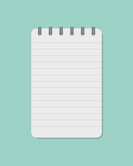 spiral notebook isolated on green background.