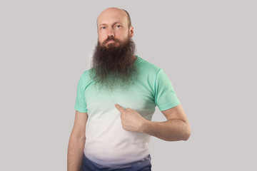 This is me! Portrait of confident middle aged bald man with long beard in light green t-shirt...