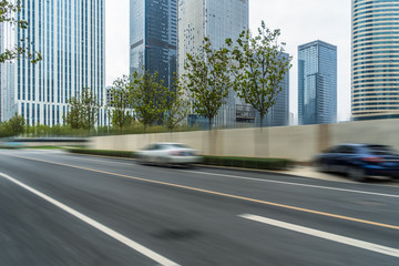 Fototapeta na wymiar blurred empty urban road and modern buildings