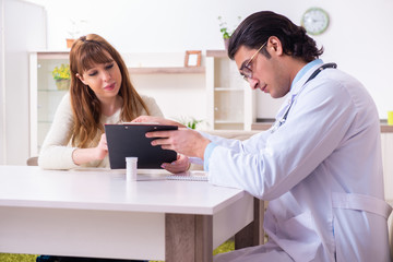 Young female patient discussing with male psychologist personal 