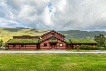 Traditional turf roof house with green hills in the foreground, Valle, Aust-Agder county, Norway