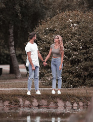 loving couple standing near a lake in a city Park