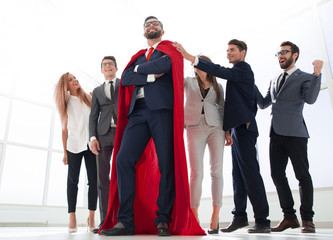 boss is a superhero and the business team is standing together