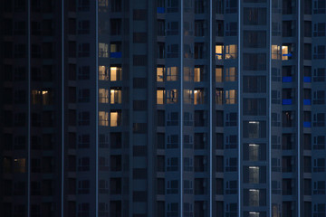 Fototapeta na wymiar construction workers building on an interior decoration of a big apartment high rise modern skyscraper. working overtime on a development project during night time.