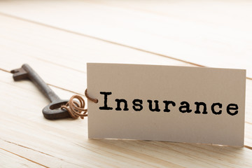 Insurance - tag on key, home security and insurance concept