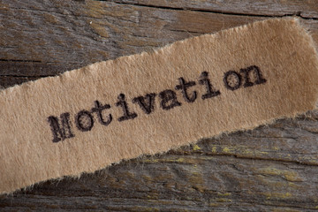 motivation word on a piece of paper close up, business creative motivation concept