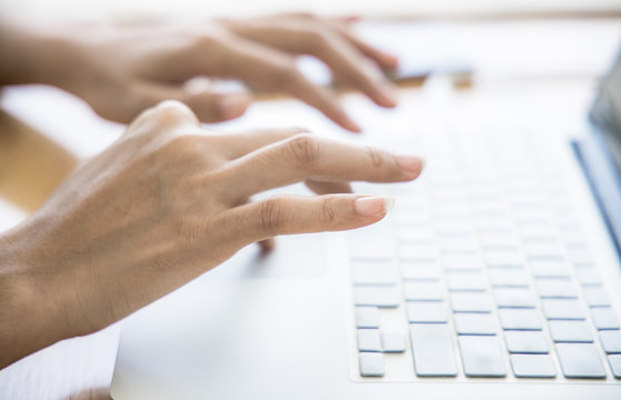 Asian woman working at home office hand on keyboard close up