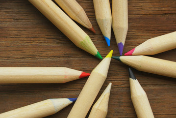 Group of pencil colors spread on wood background , brainstorm concept.
