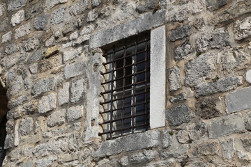 Fototapeta na wymiar Windows with metal grilles, view from the street