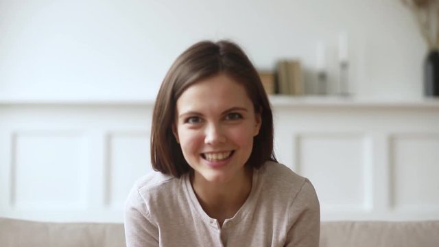 Happy young woman youtuber laughing recording vlog looking at camera