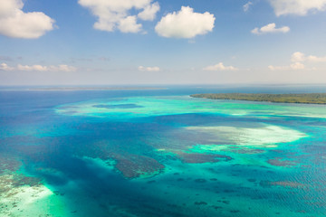 Coral reefs and atolls in the tropical sea, top view. Turquoise sea water and beautiful shallows. Philippine nature.